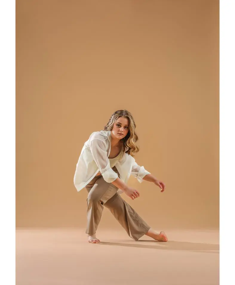 Woman in white shirt performing contemporary dance