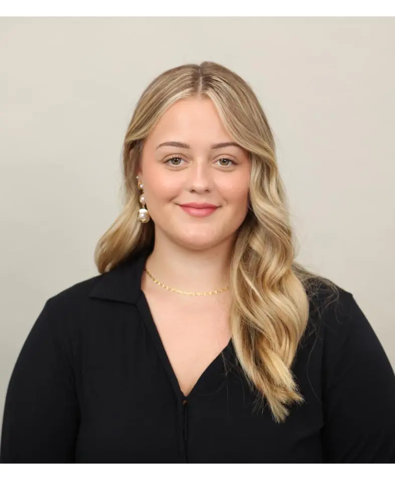 Smiling young woman with wavy blonde hair